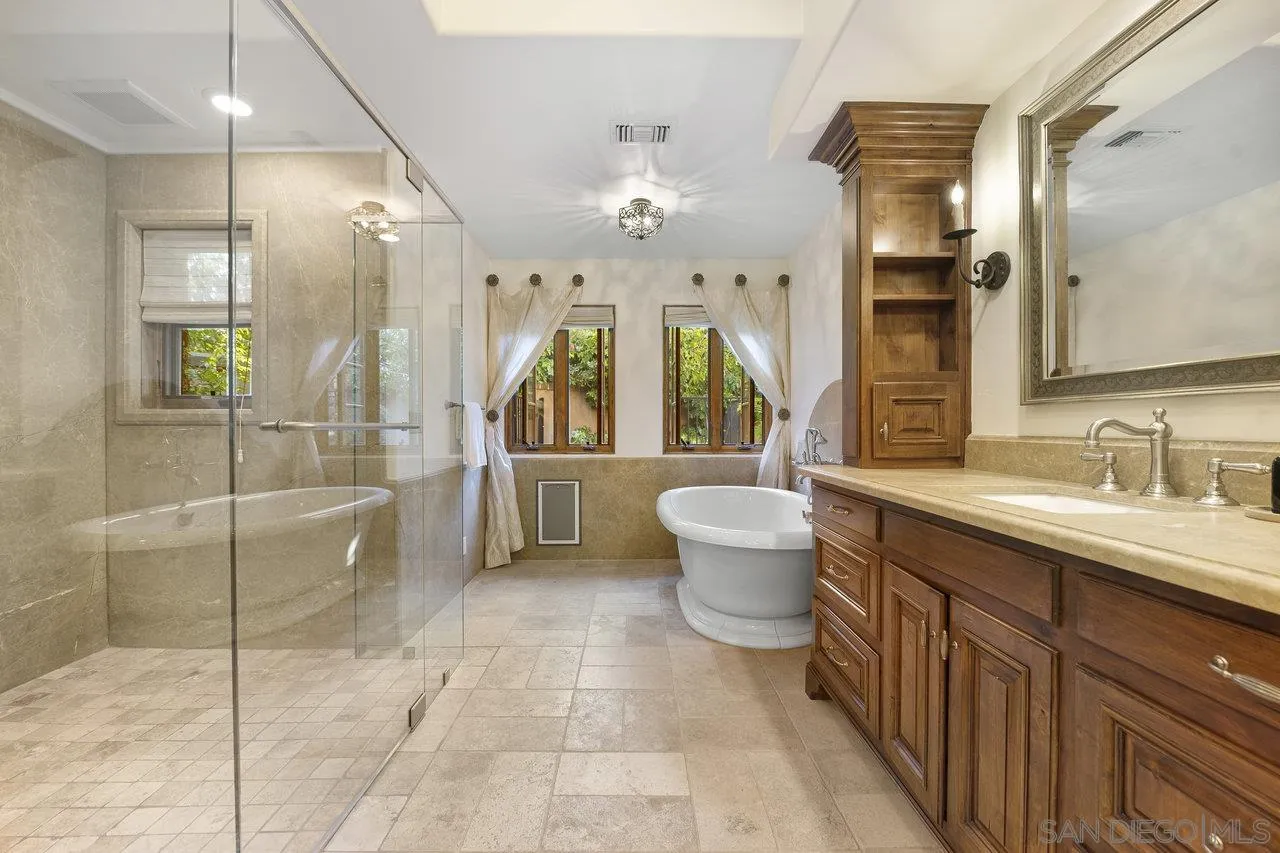 6101 Camino Selva Rancho Santa Fe, CA 92067 - Photo 22 of 35 a spacious bathroom with a granite countertop sink a toilet a mirror and shower