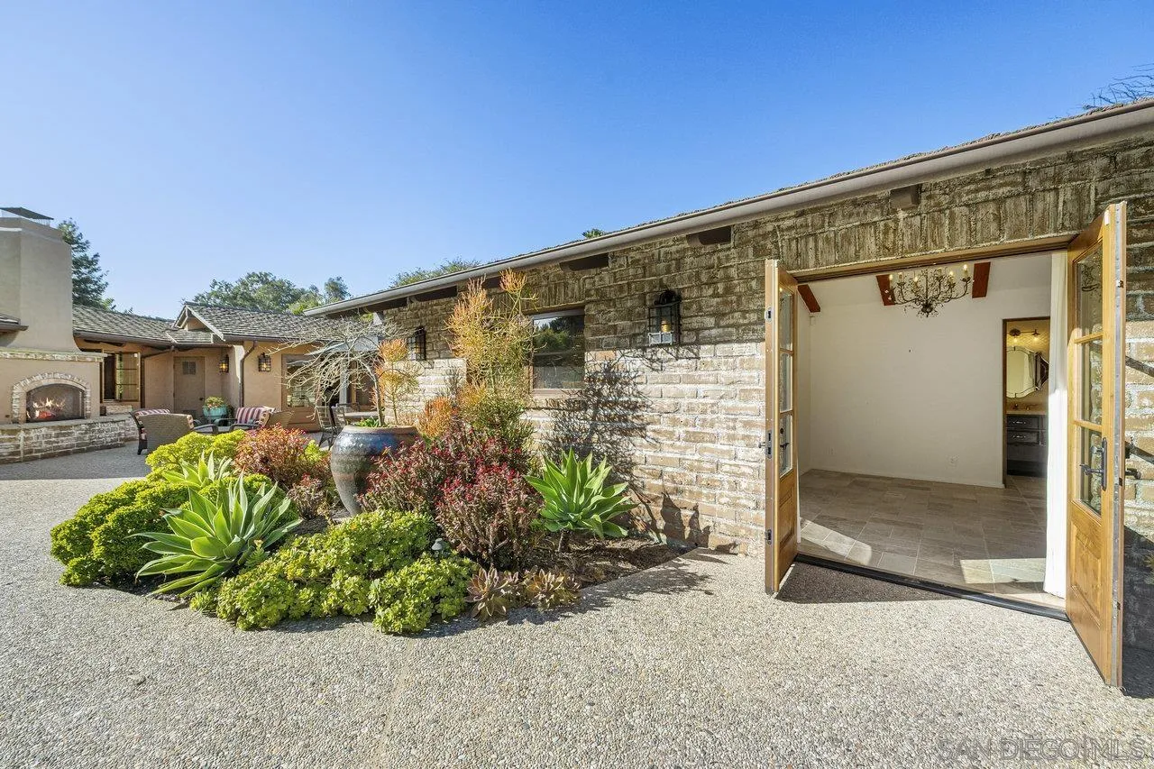 6101 Camino Selva Rancho Santa Fe, CA 92067 - Photo 30 of 35 a front view of a house with a glass door and glass door