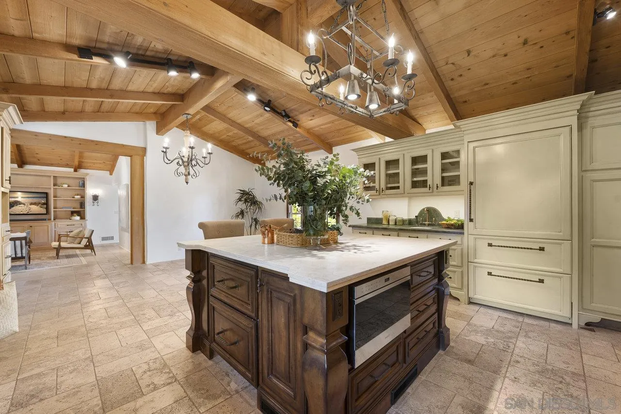 6101 Camino Selva Rancho Santa Fe, CA 92067 - Photo 8 of 35 a kitchen with a stove and a table