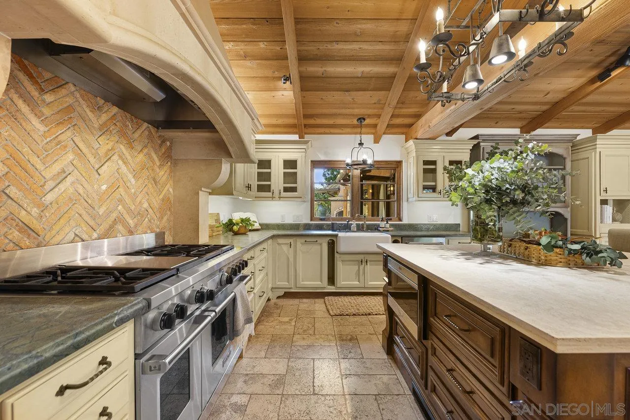 6101 Camino Selva Rancho Santa Fe, CA 92067 - Photo 10 of 35 a kitchen with a sink stove and cabinets