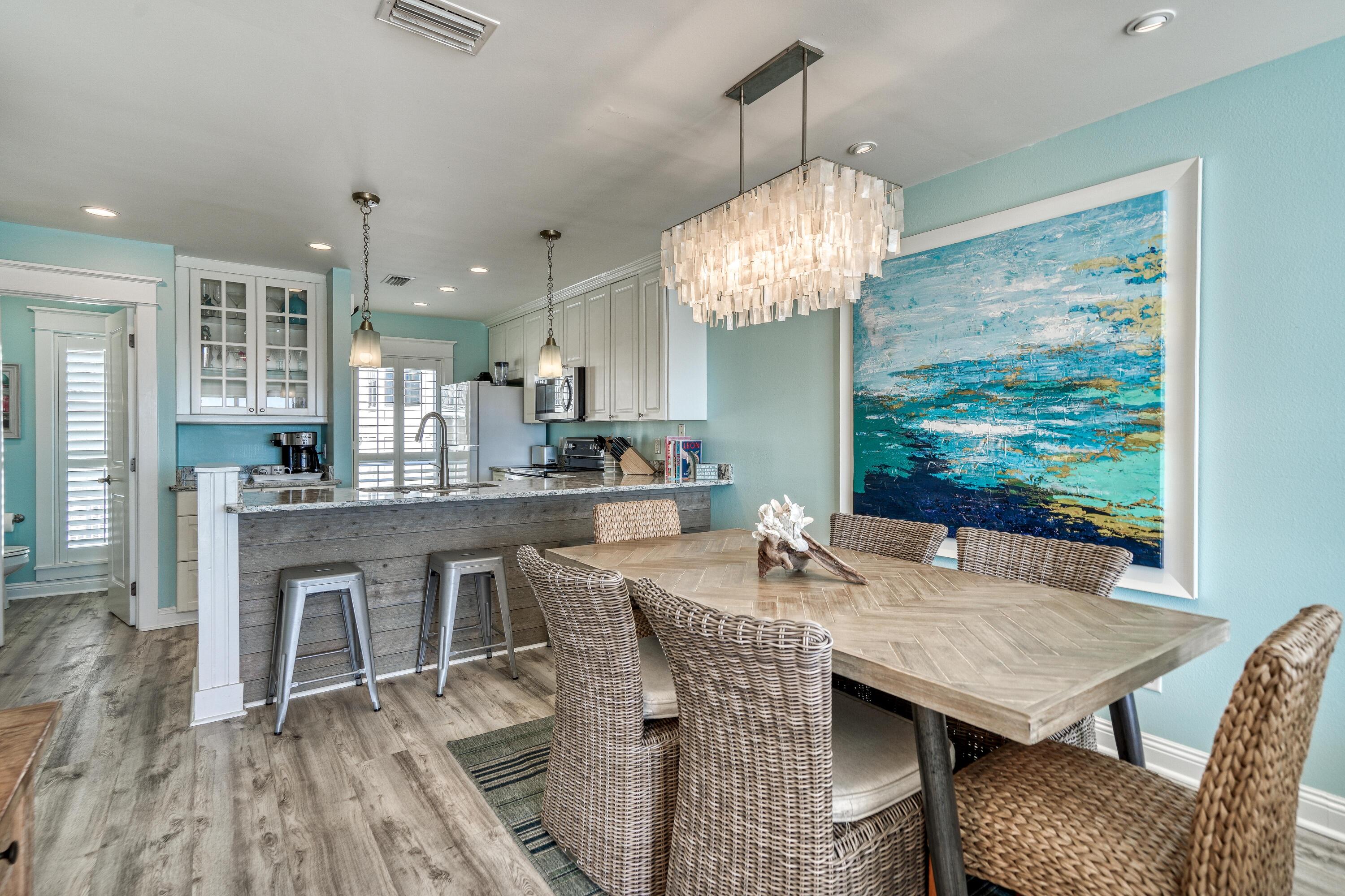 681 Eastern Lake Road, Unit 3 Santa Rosa Beach, FL 32459 - Photo 5 of 64 a view of a dining room with furniture a chandelier and wooden floor