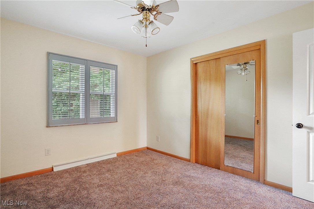 3215 Stanley Road Akron, OH 44333 - Photo 24 of 30 Carpeted spare room with baseboard heating and ceiling fan