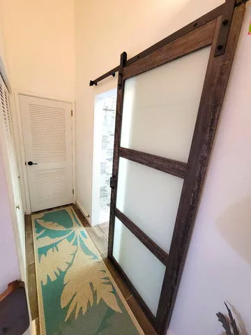 a view of a hallway with wooden floor and staircase