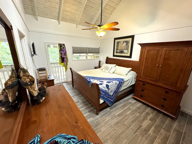 a bed room with a bed and a tv