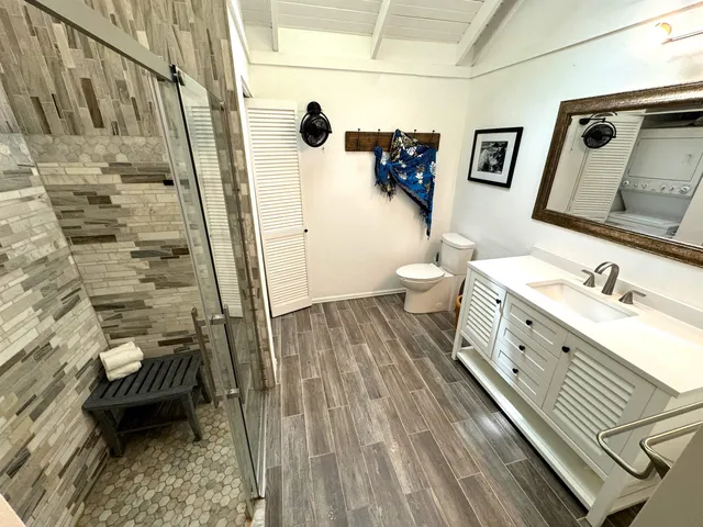 a bathroom with a double vanity sink toilet and shower
