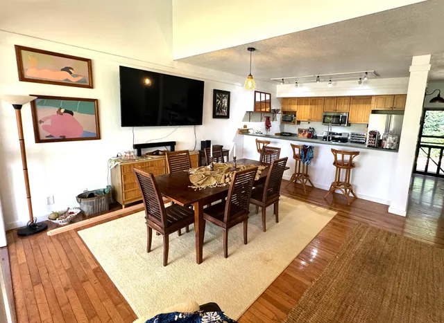 a view of a dining room with furniture and wooden floor