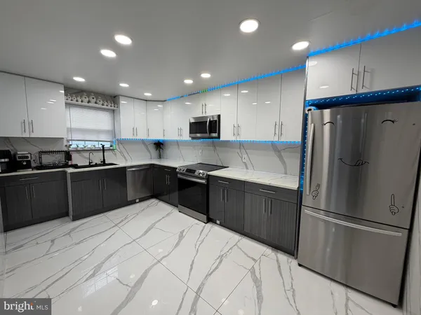 a kitchen with a refrigerator and a sink