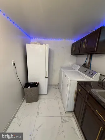 a utility room with sink dryer and washer