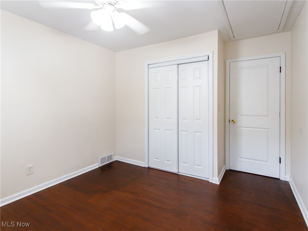 31827 Glenhurst Road Willowick, OH 44095 - Photo 23 of 44 Unfurnished bedroom with dark wood-type flooring, baseboards, a closet, and a ceiling fan