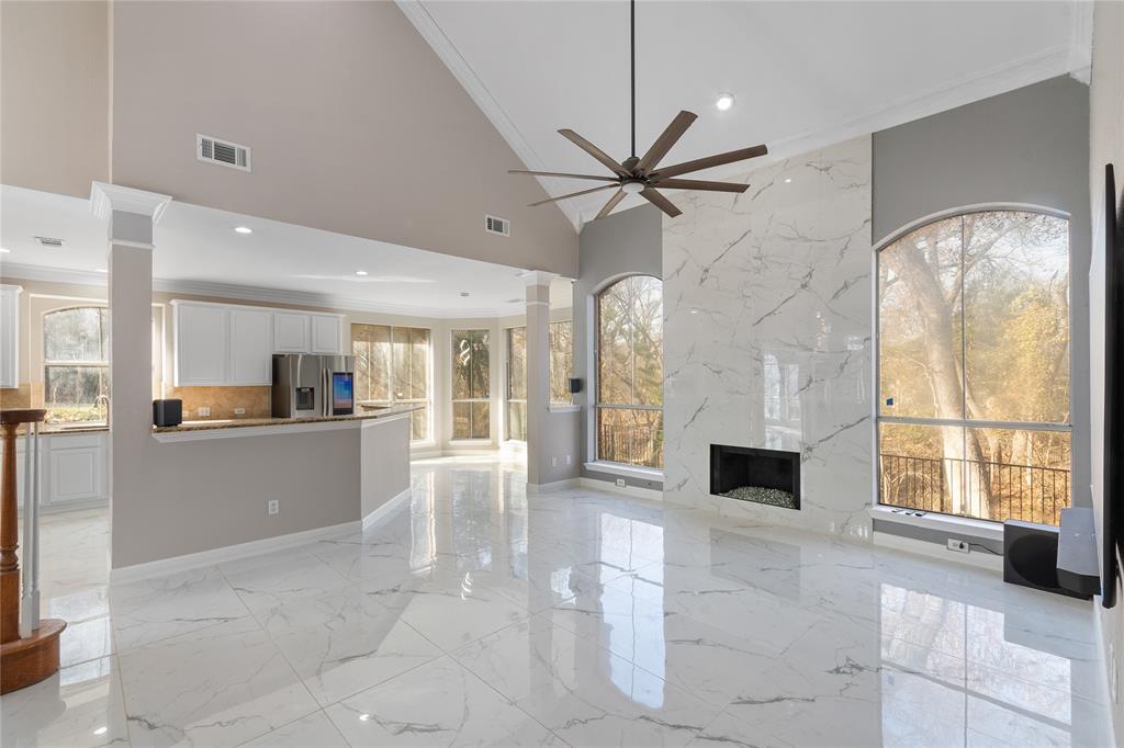 225 Freedom Court Rockwall, TX 75032 - Photo 9 of 28 a living room with stainless steel appliances kitchen island granite countertop furniture and a large window