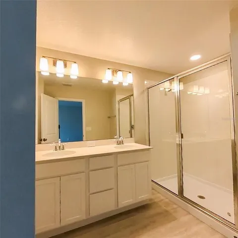 a large kitchen with stainless steel appliances granite countertop a large counter top and a stove with wooden floor