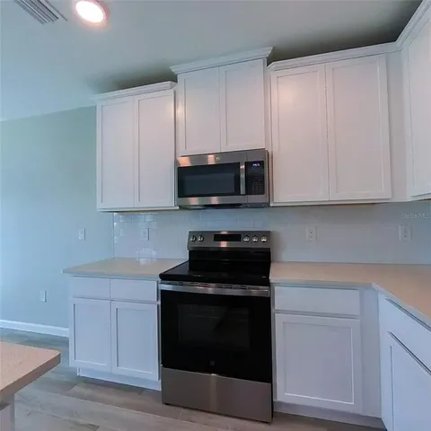a bathroom with a double vanity sink mirror and shower