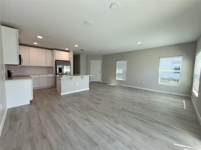 an empty room with windows and closet