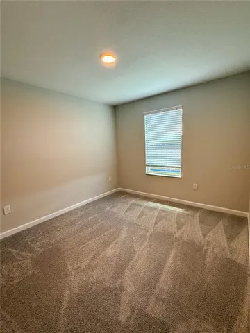 a view of an empty room and a window