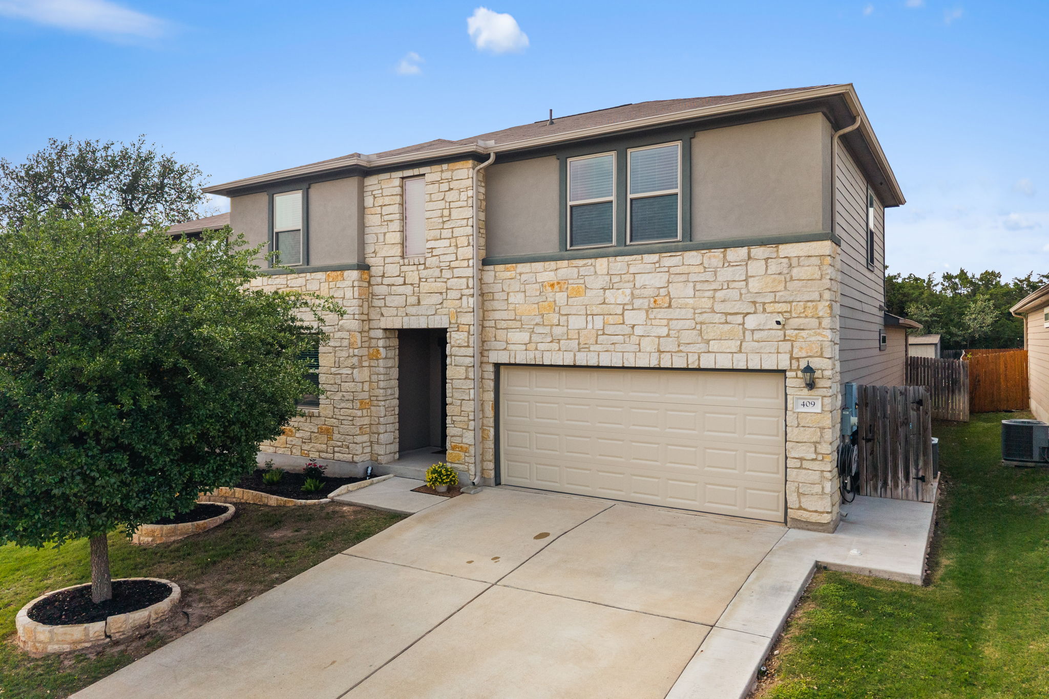 409 Limestone Road Liberty Hill, TX 78642 - Photo 3 of 35 a front view of a house with garden