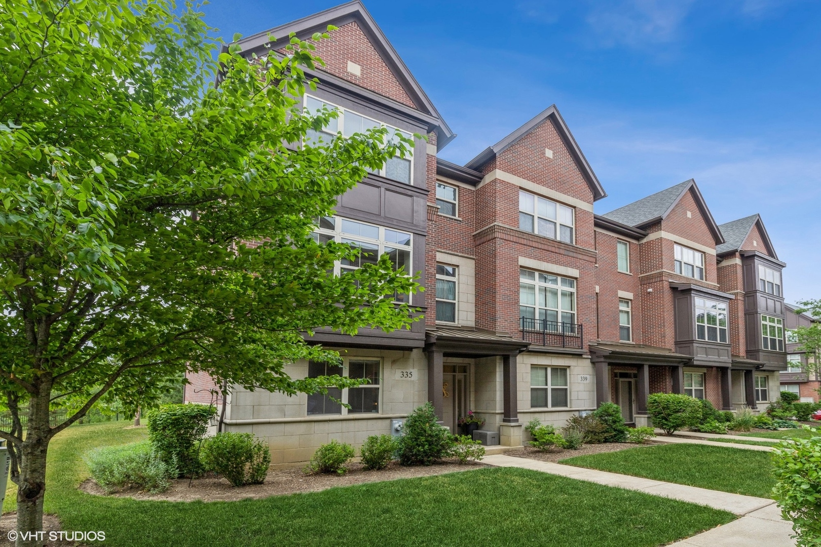 335 Alpine Springs Drive, Unit 335 Vernon Hills, IL 60061 - Photo 1 of 10 a front view of a house with a yard