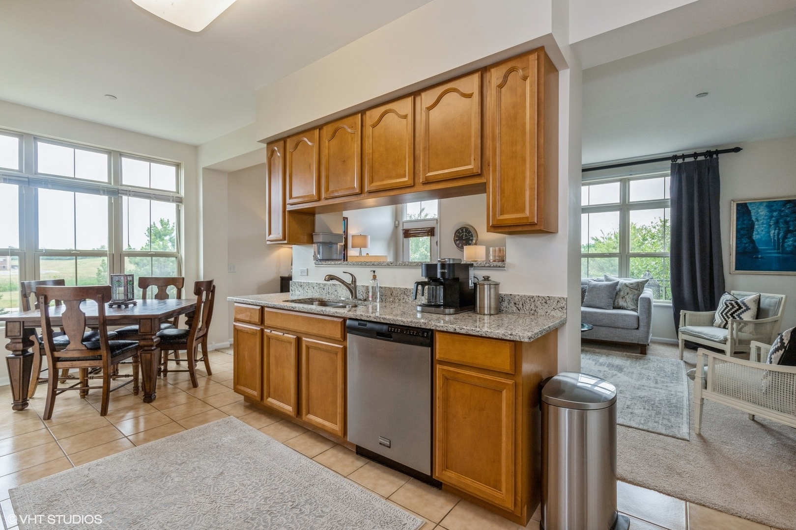 335 Alpine Springs Drive, Unit 335 Vernon Hills, IL 60061 - Photo 5 of 10 a kitchen with a stove a sink a dining table and chairs
