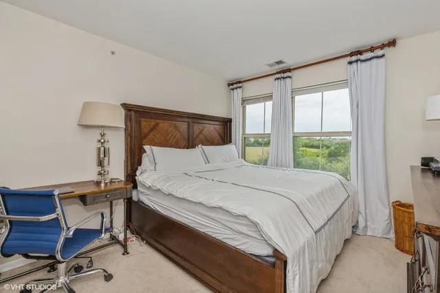 a bedroom with a bed and a chair