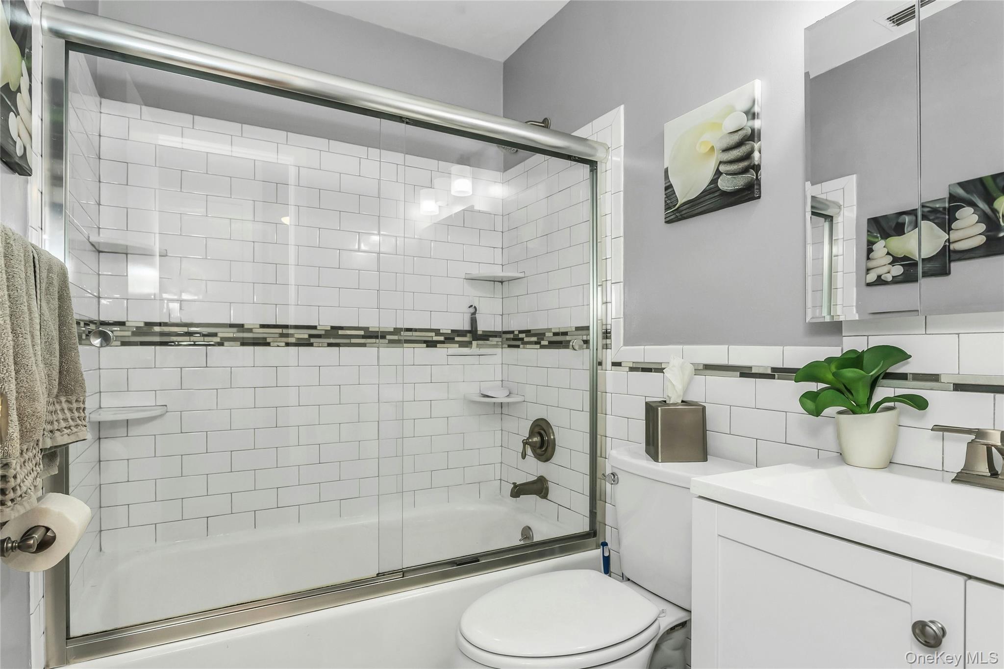 650 Newbridge Road, Unit 9 East Meadow, NY 11554 - Photo 7 of 9 a bathroom with a sink a toilet and shower