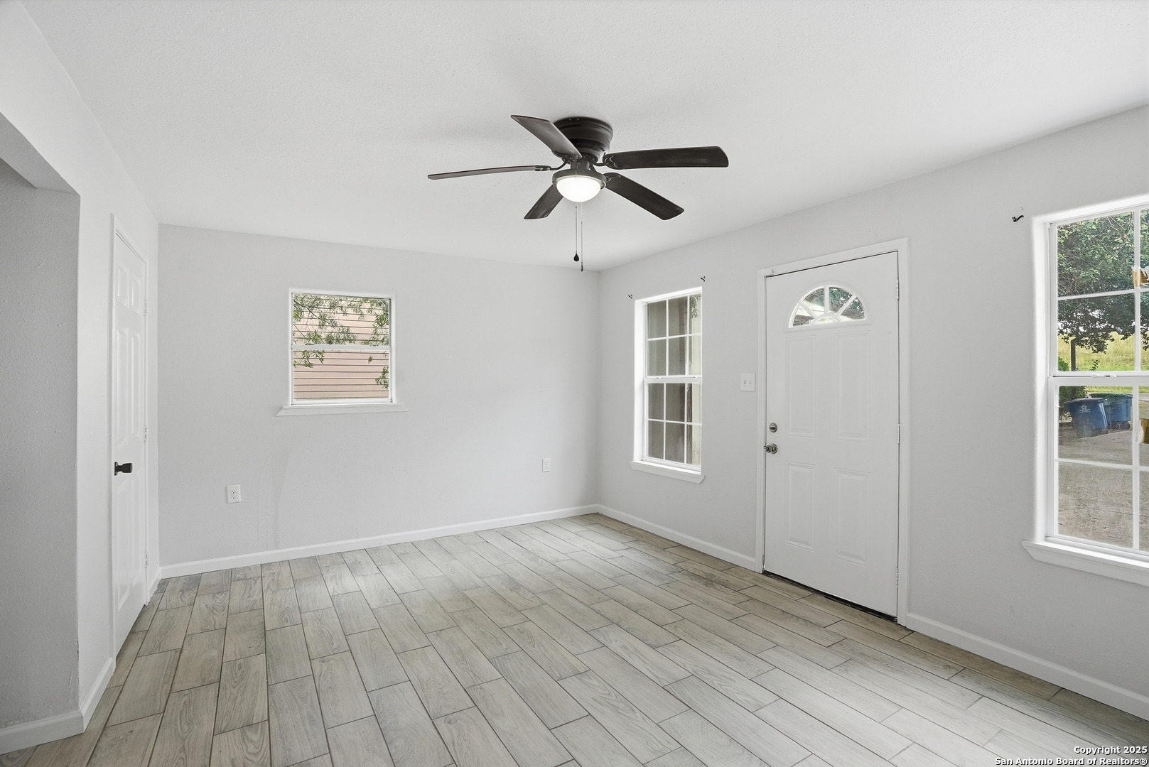 807 Northeast Frontage Road Beeville, TX 78102 - Photo 16 of 49 a view of empty room with wooden floor and fan