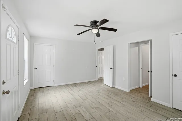 a view of empty room with wooden floor