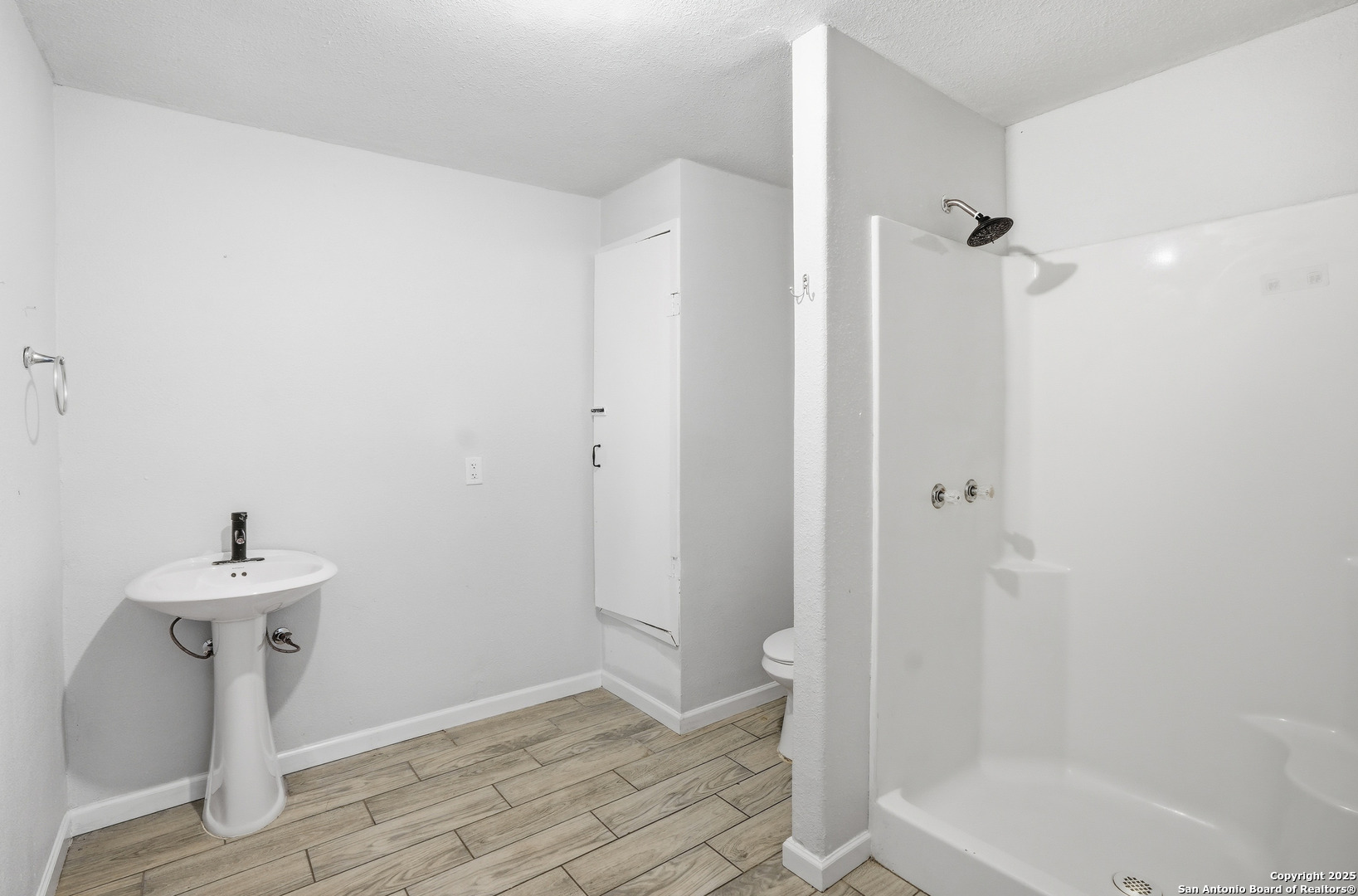 807 Northeast Frontage Road Beeville, TX 78102 - Photo 19 of 49 a bathroom with a sink a toilet and shower