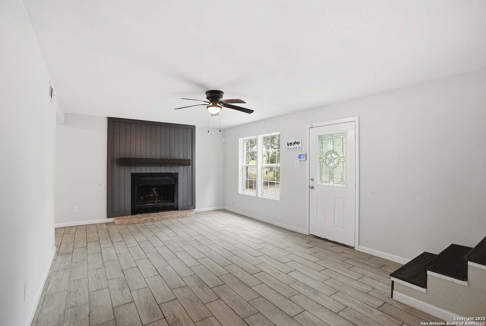 807 Northeast Frontage Road Beeville, TX 78102 - Photo 2 of 49 a view of empty room with wooden floor and fan