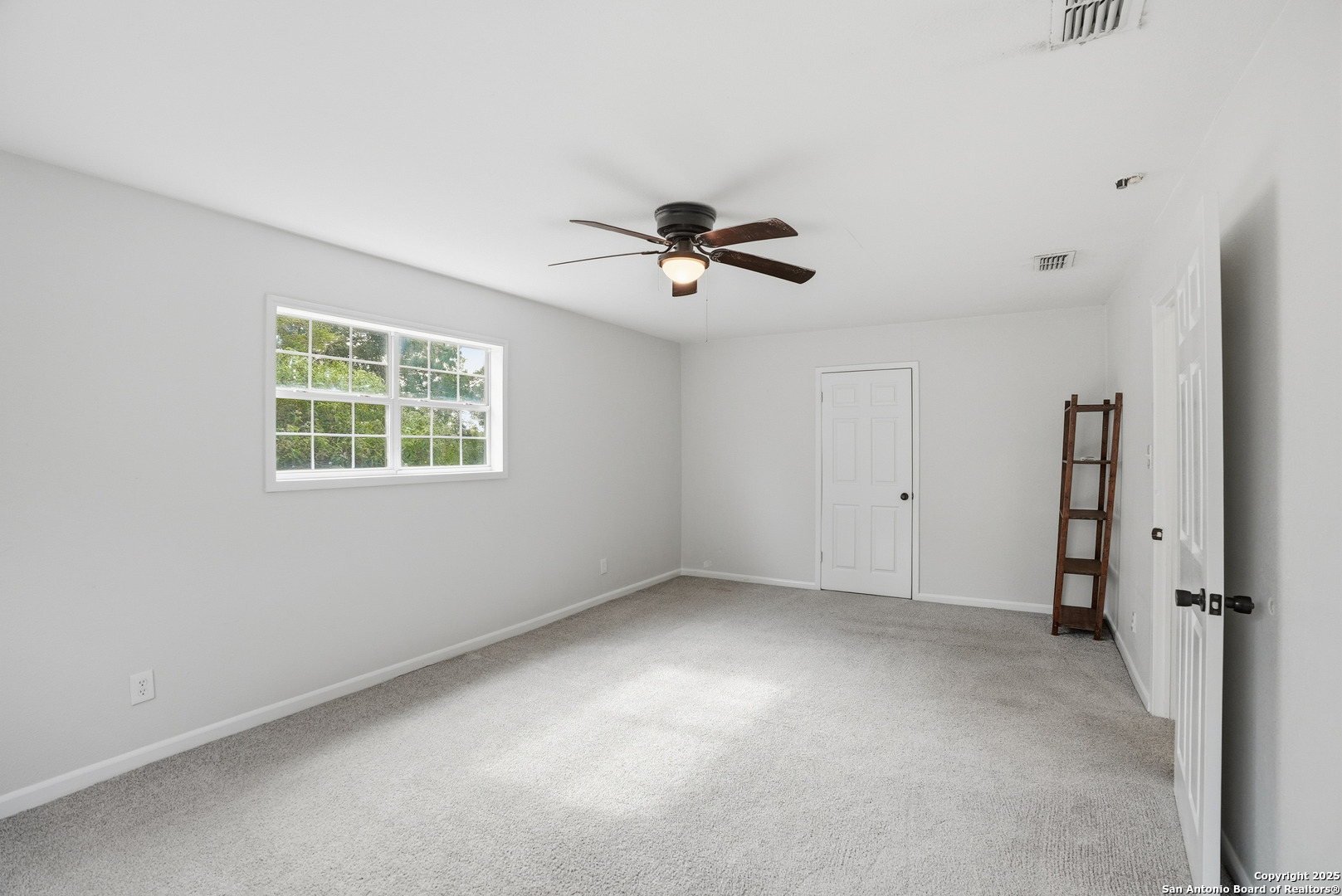 807 Northeast Frontage Road Beeville, TX 78102 - Photo 29 of 49 wooden floor in an empty room with a window