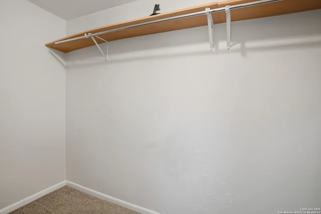 a view of a room with shelf on the wall