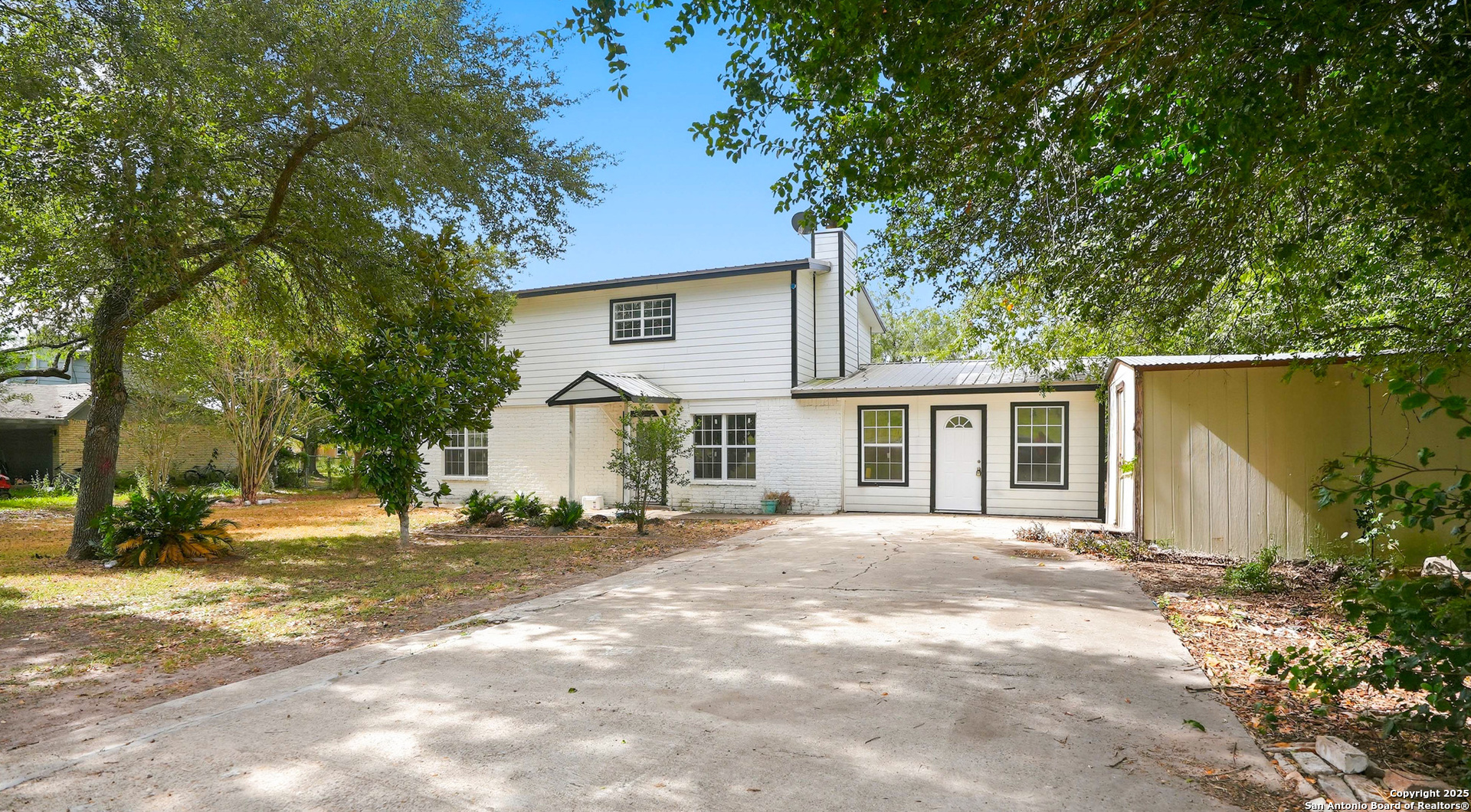 807 Northeast Frontage Road Beeville, TX 78102 - Photo 34 of 49 a front view of a house with a yard and trees