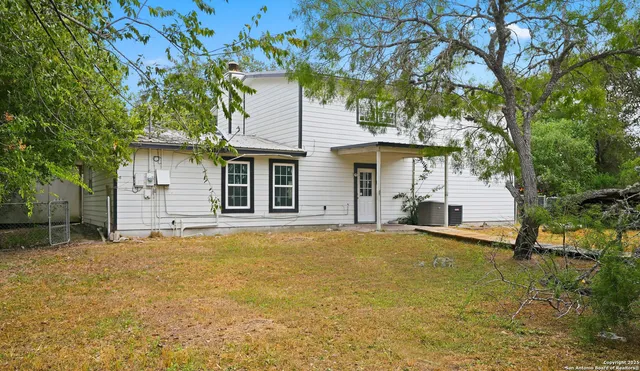 a house that has a tree in front of it