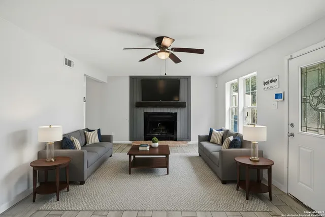 a living room with furniture and a fireplace