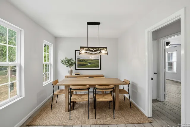 a dining room with furniture and window