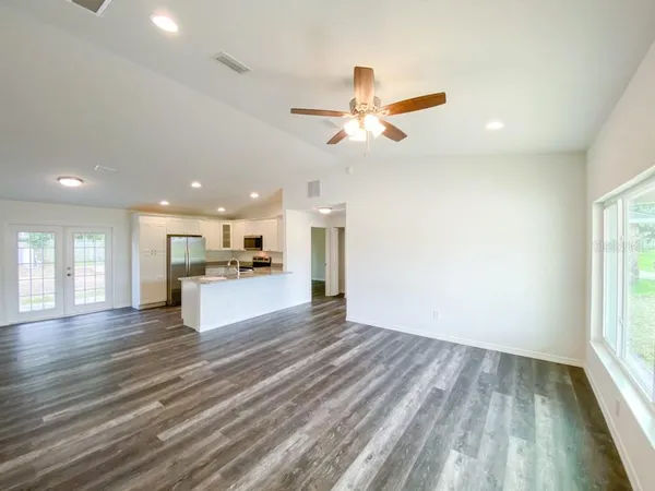a view of kitchen with sink and refrigerator