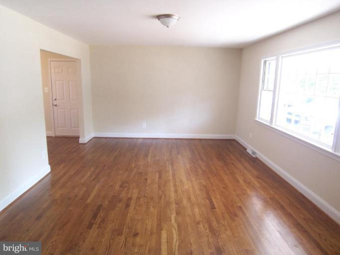 2400 Kingsway Road Fort Washington, MD 20744 - Photo 2 of 15 an empty room with wooden floor and windows