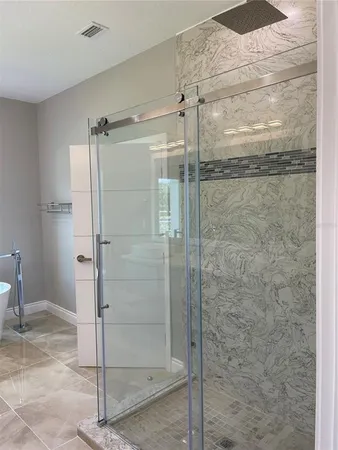 a bathroom with a glass shower door