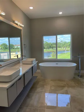 a bathroom with a bathtub and window