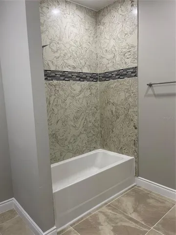 a bathroom with a shower and a bathtub