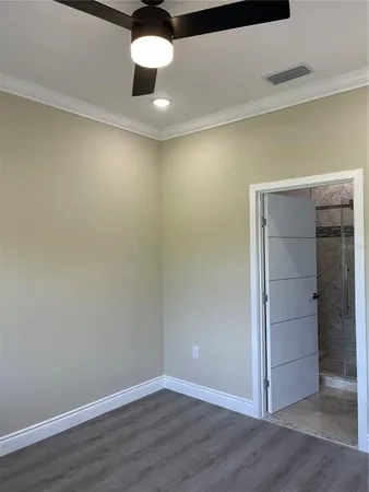 a view of an empty room and wooden floor
