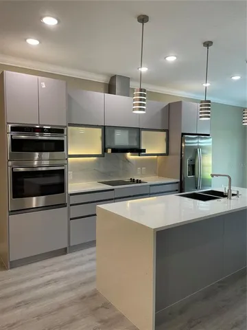 a large kitchen with a large counter top kitchen appliances and a center island
