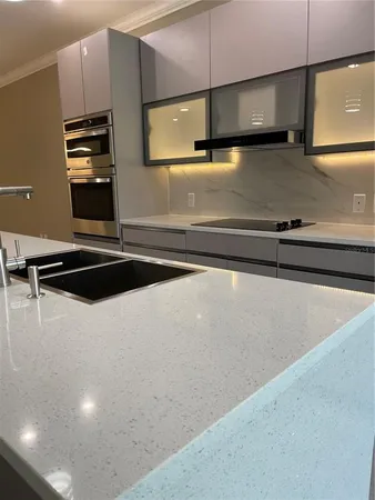 a kitchen with a sink and a stove