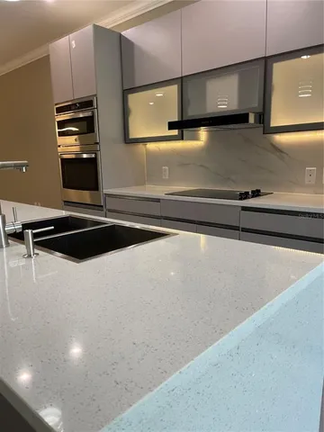 a kitchen with a sink and a stove