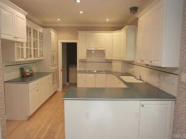 2308 Primrose Valley Court Raleigh, NC 27613 - Photo 3 of 12 a large kitchen with kitchen island a stove a sink and a refrigerator