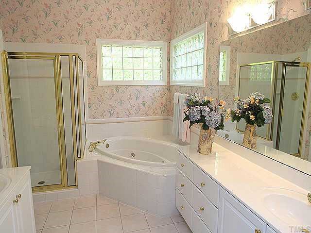 2308 Primrose Valley Court Raleigh, NC 27613 - Photo 7 of 12 a bathroom with a tub sink and mirror