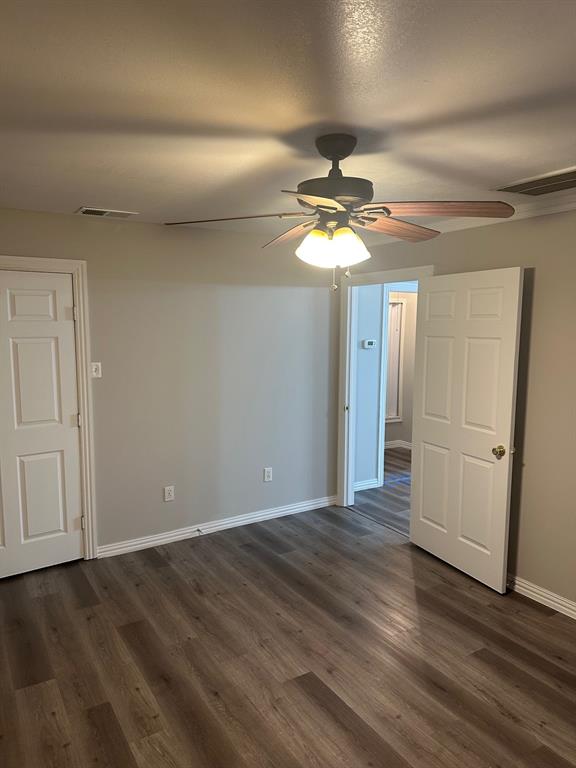 8280 Highway 78 Blue Ridge, TX 75424 - Photo 13 of 21 Unfurnished bedroom with dark wood finished floors and ceiling fan