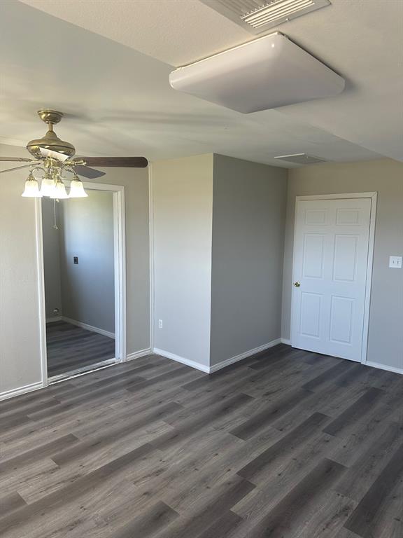 8280 Highway 78 Blue Ridge, TX 75424 - Photo 16 of 21 Unfurnished bedroom featuring dark wood-style floors, a ceiling fan, and a closet