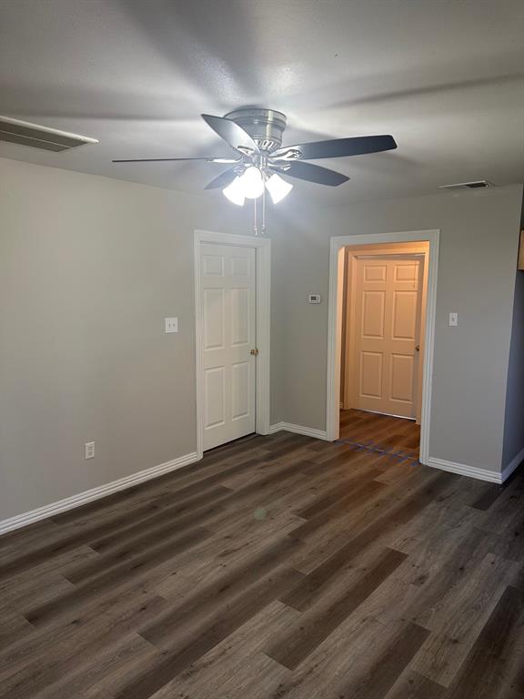 8280 Highway 78 Blue Ridge, TX 75424 - Photo 3 of 21 Unfurnished room featuring dark wood-style floors and a ceiling fan