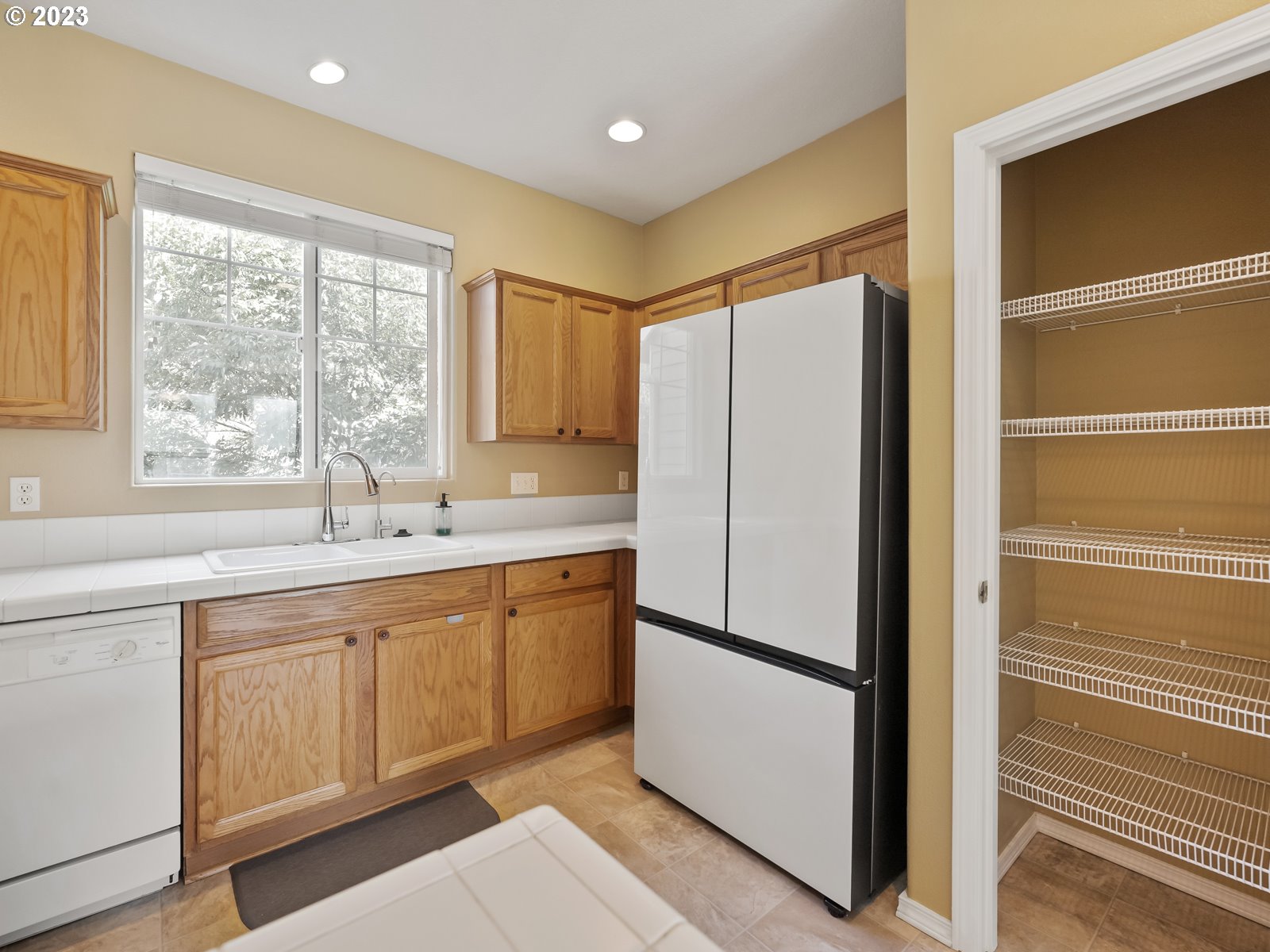 12226 Southeast Long Street Portland, OR 97236 - Photo 11 of 29 a kitchen with stainless steel appliances granite countertop a refrigerator and a sink