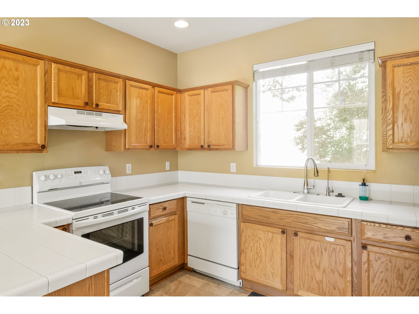 12226 Southeast Long Street Portland, OR 97236 - Photo 12 of 29 a kitchen with a sink stove and cabinets