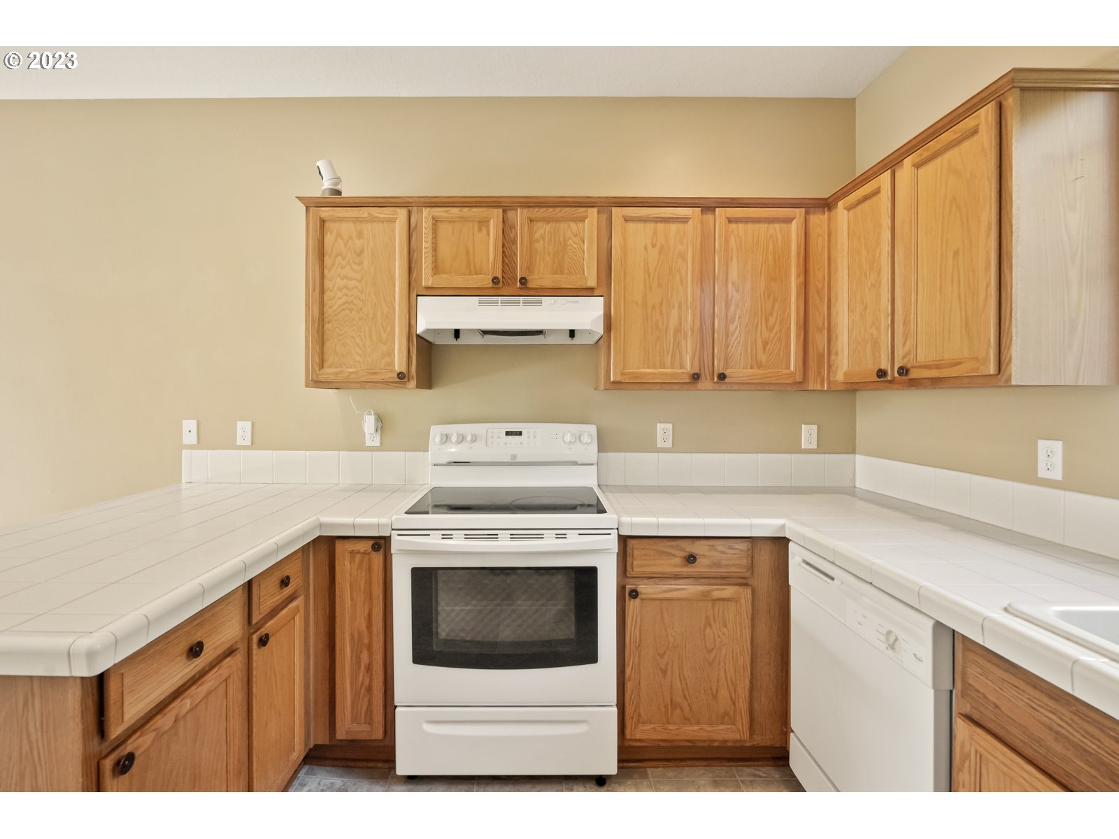12226 Southeast Long Street Portland, OR 97236 - Photo 13 of 29 a kitchen with a stove top oven sink and cabinets